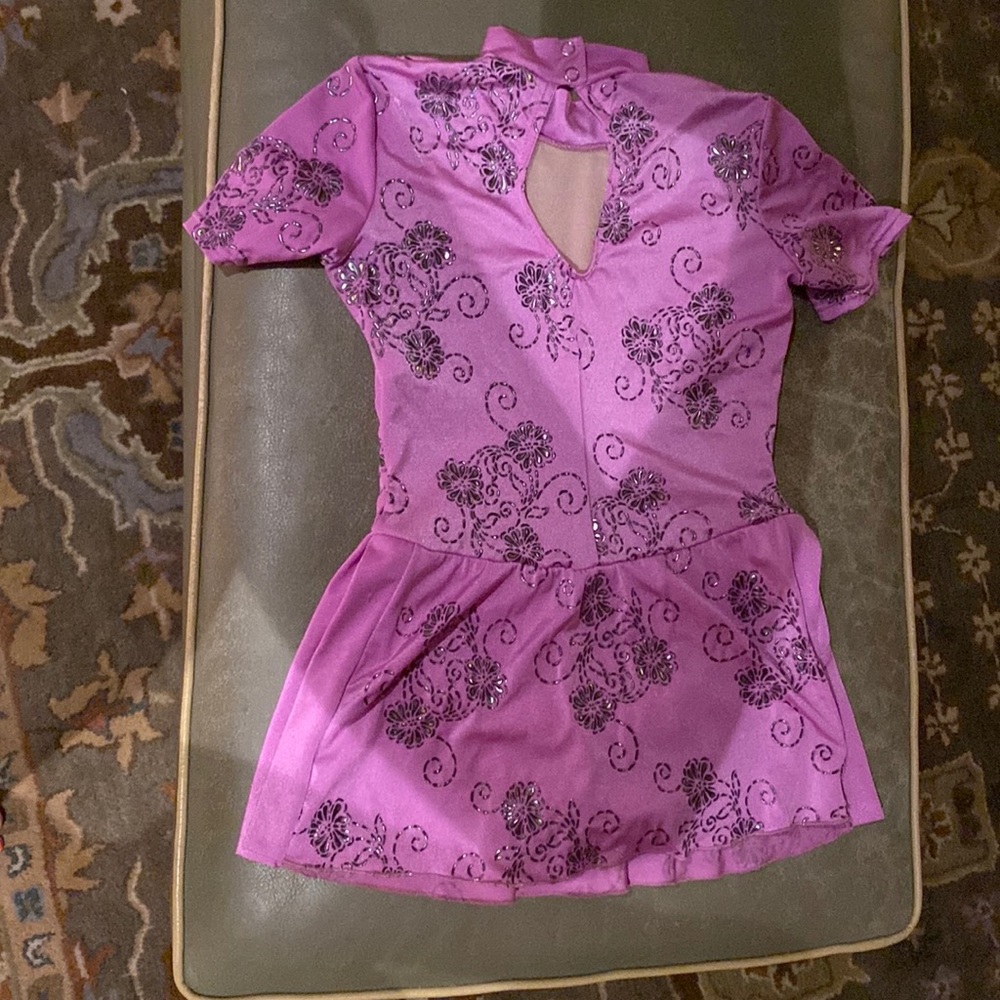 Lite purple with embroidered flowers that shine. Well made and gentle worn